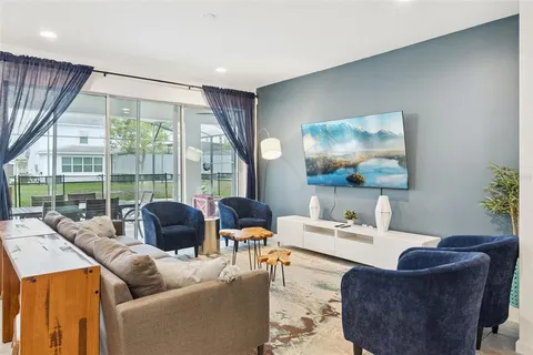 a living room with furniture and a large window