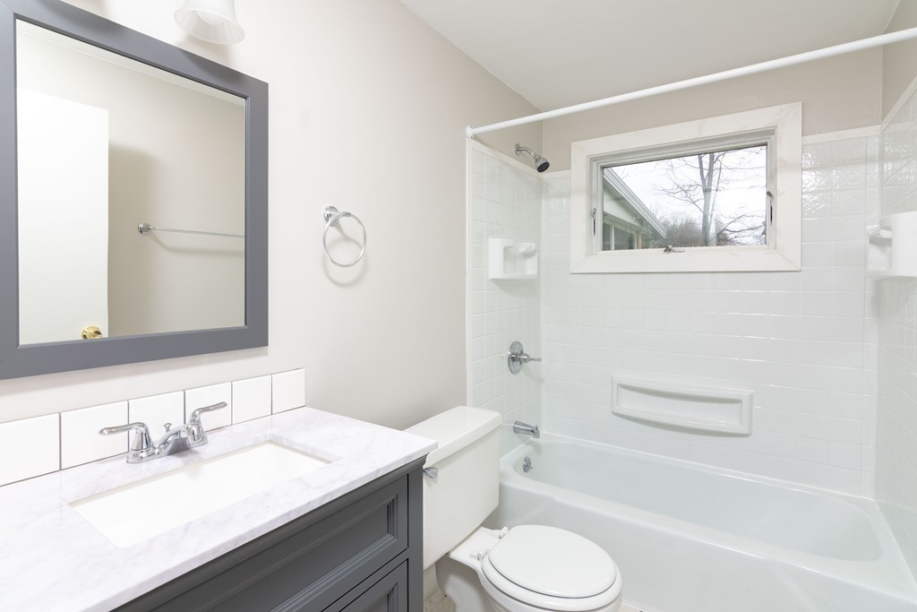 63 Finch Road Springfield, MA 01119 - Photo 13 of 18 a bathroom with a granite countertop sink toilet a mirror and bathtub