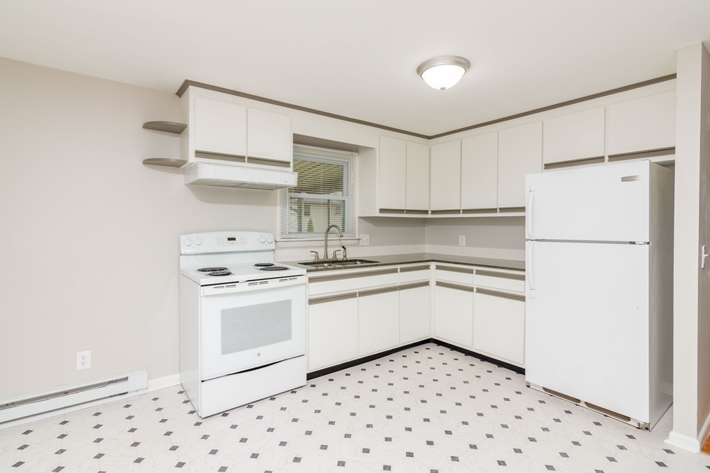 63 Finch Road Springfield, MA 01119 - Photo 3 of 18 a kitchen with granite countertop appliances a sink and a refrigerator