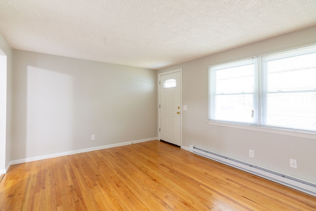 63 Finch Road Springfield, MA 01119 - Photo 6 of 18 wooden floor in an empty room with a window