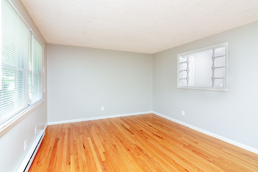 63 Finch Road Springfield, MA 01119 - Photo 8 of 18 an empty room with wooden floor and windows