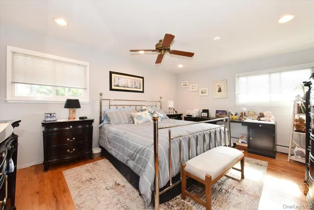 a bedroom with a bed a chandelier and a dresser