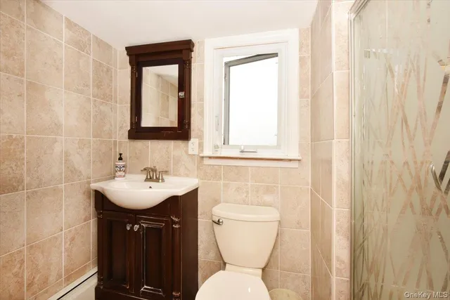 a bathroom with a toilet a sink and a mirror