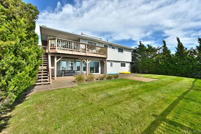 a view of a house with a yard balcony and sitting area