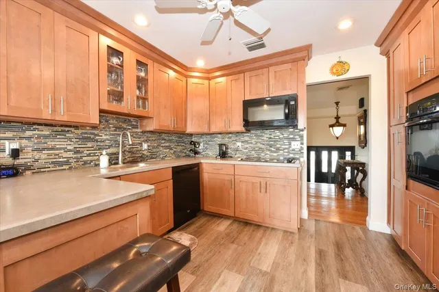 a kitchen with stainless steel appliances granite countertop wooden cabinets a stove and a sink