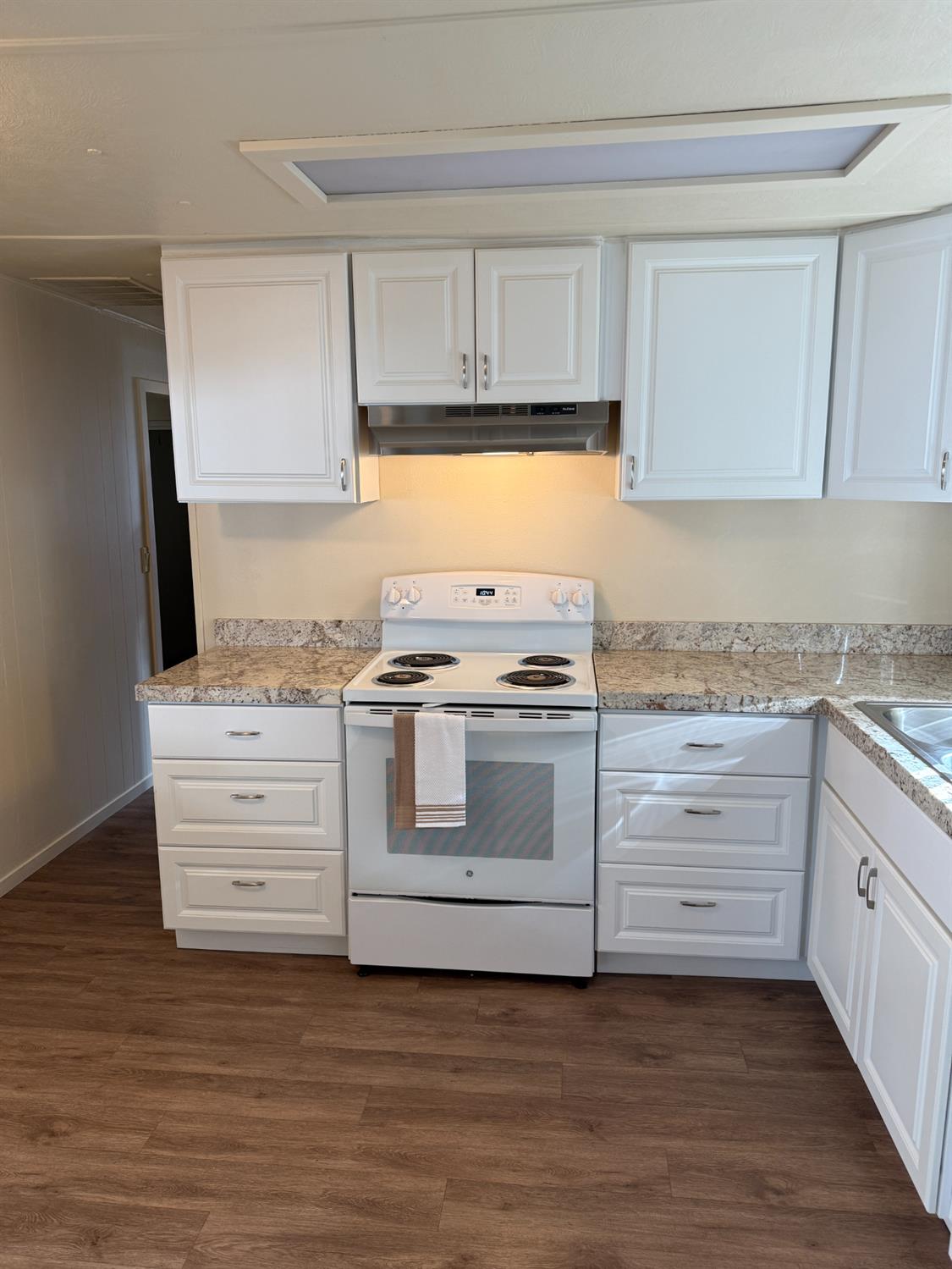2107 Patterson Road, Unit 31 Riverbank, CA 95367 - Photo 6 of 34 a kitchen with granite countertop white cabinets and white appliances