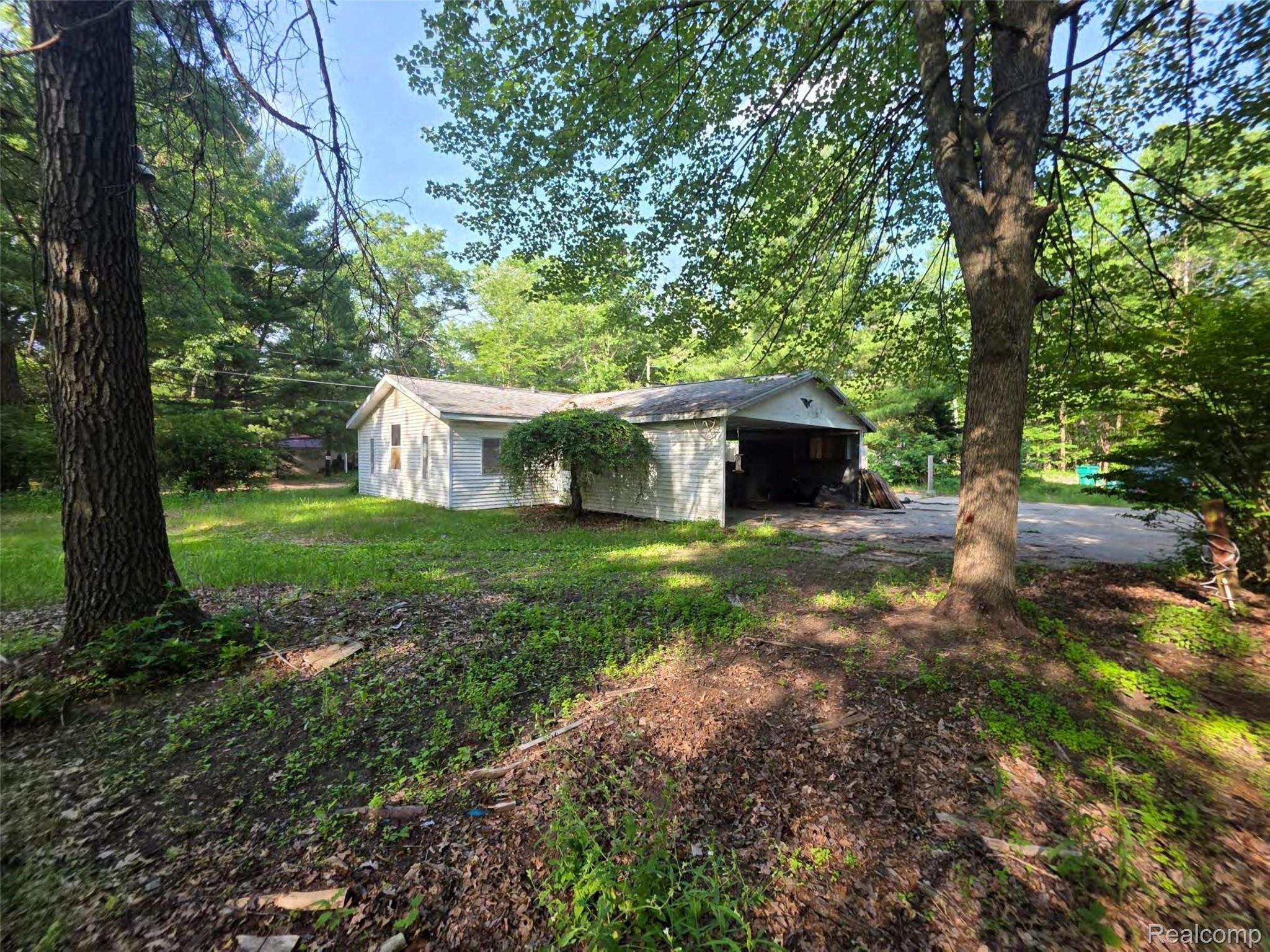 5420 Randy Drive Prescott, MI 48756 - Photo 16 of 31 Detached garage structure featuring a pitched roofline and an open bay