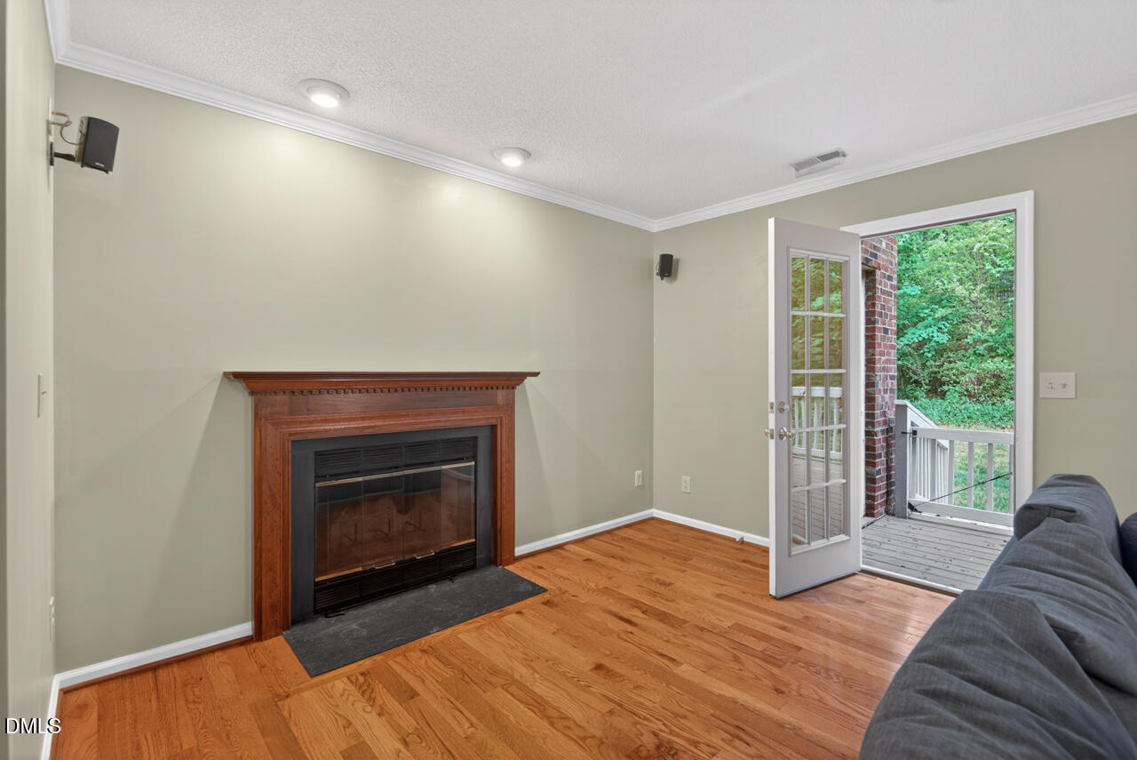 3307 Coachman's Way Durham, NC 27705 - Photo 23 of 50 a view of empty room with wooden floor and fireplace