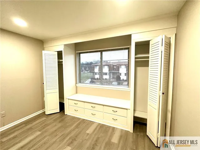 a view of room with window and wooden floor