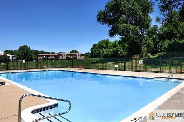 a view of a swimming pool with a yard