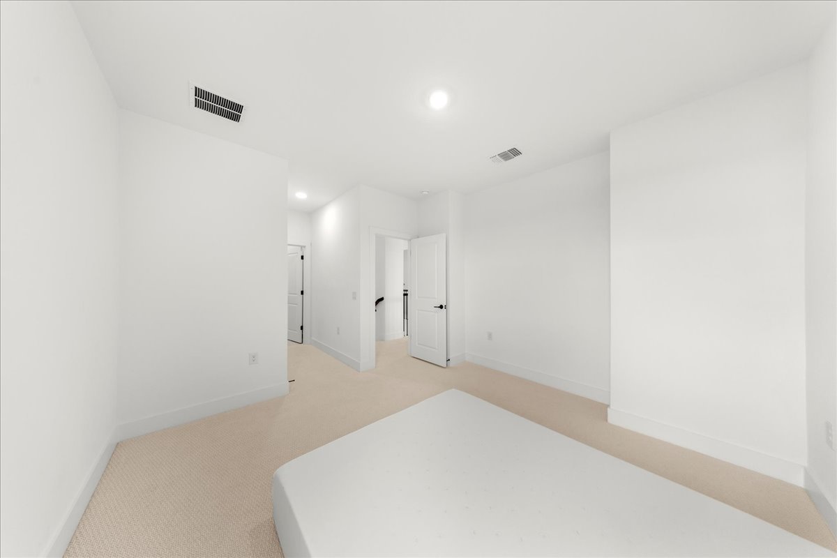 8700 Olmsted Way Austin, TX 78744 - Photo 29 of 40 Unfurnished bedroom featuring light colored carpet and recessed lighting