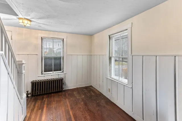 a view of a hallway with wooden floor and stairs
