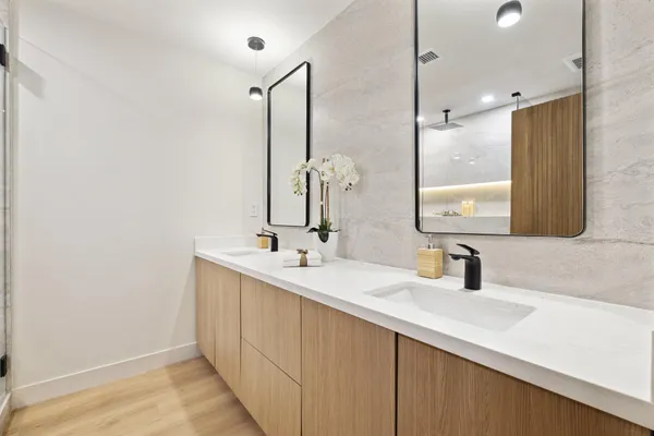 a bathroom with a double vanity sink and a mirror