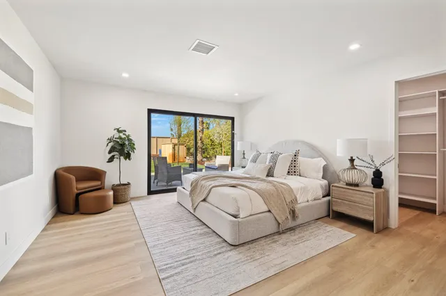 a spacious bedroom with a large bed and a couch