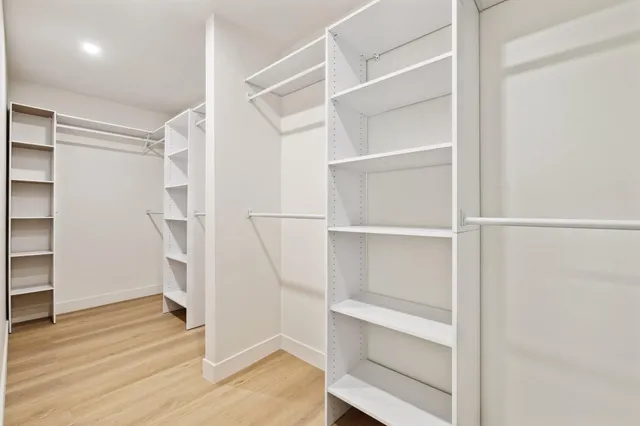 a view of walk in closet with empty racks