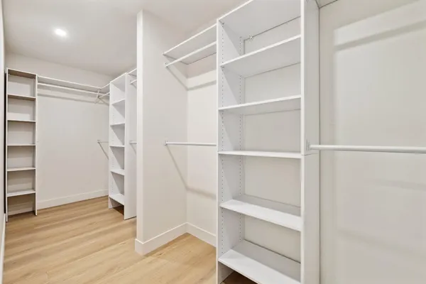 a view of walk in closet with empty racks