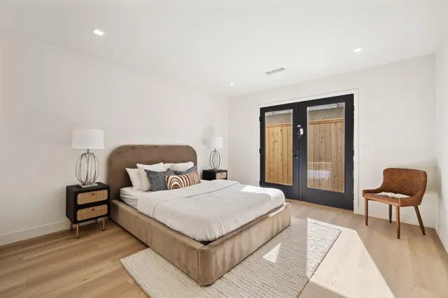 a bedroom with a bed and chair