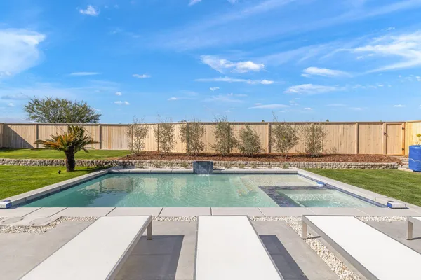 a view of a swimming pool and a yard
