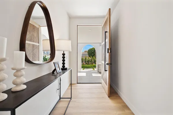 a hallway with a large window and mirror