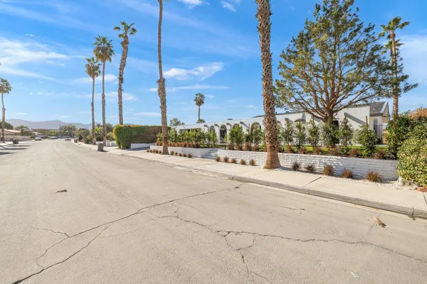 a view of a street with a building in the background