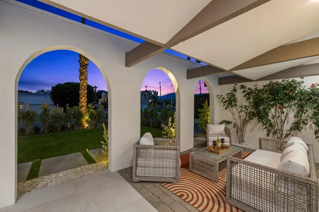 a balcony with furniture and a garden