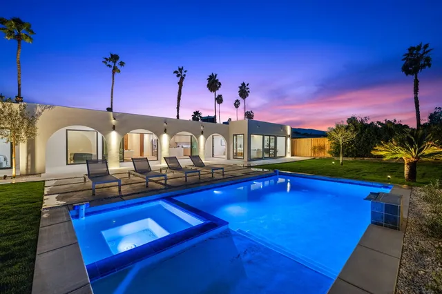 a view of swimming pool with a lounge chairs