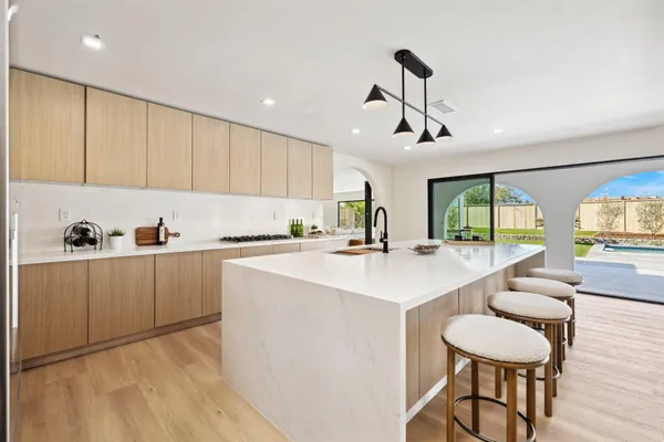 a kitchen with a table chairs stove and cabinets