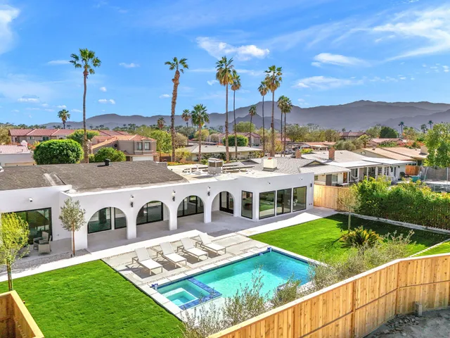 a view of multiple houses with a big yard