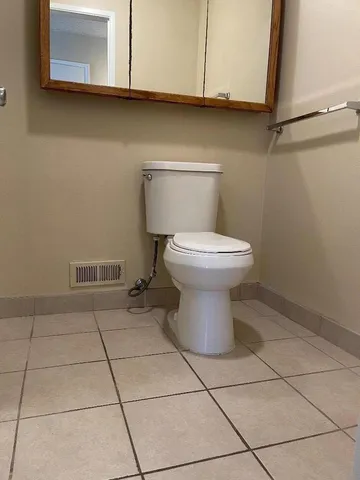 a bathroom with a toilet and a washing machine