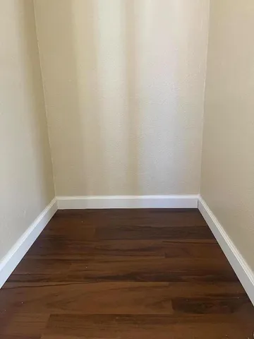 a view of room with wooden floor