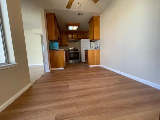a view of a kitchen with wooden floor