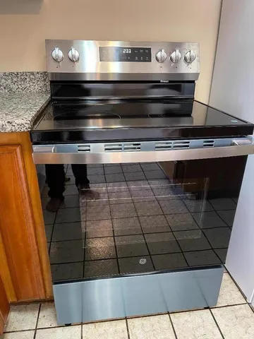 a stove top oven sitting inside of a kitchen