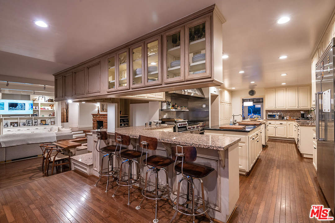 20 Toluca Estates Drive Toluca Lake, CA 91602 - Photo 19 of 46 a large kitchen with lots of counter space and stainless steel appliances