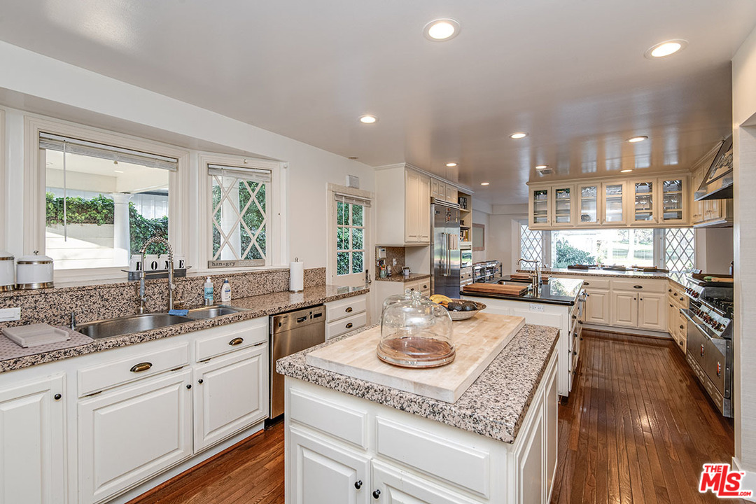 20 Toluca Estates Drive Toluca Lake, CA 91602 - Photo 24 of 46 a kitchen with a sink a stove and cabinets
