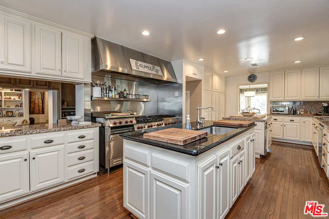 20 Toluca Estates Drive Toluca Lake, CA 91602 - Photo 25 of 46 a kitchen with stainless steel appliances granite countertop a stove and a sink