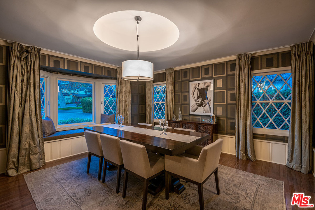 20 Toluca Estates Drive Toluca Lake, CA 91602 - Photo 26 of 46 a view of a dining room with furniture a chandelier and wooden floor