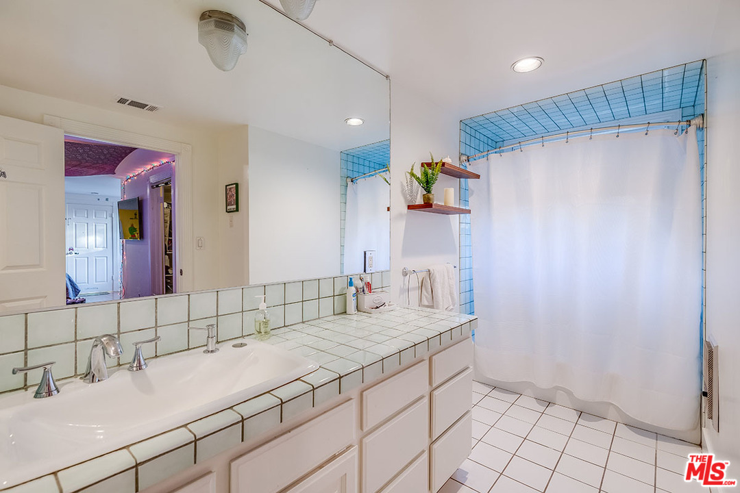 20 Toluca Estates Drive Toluca Lake, CA 91602 - Photo 39 of 46 a bathroom with a sink and a mirror