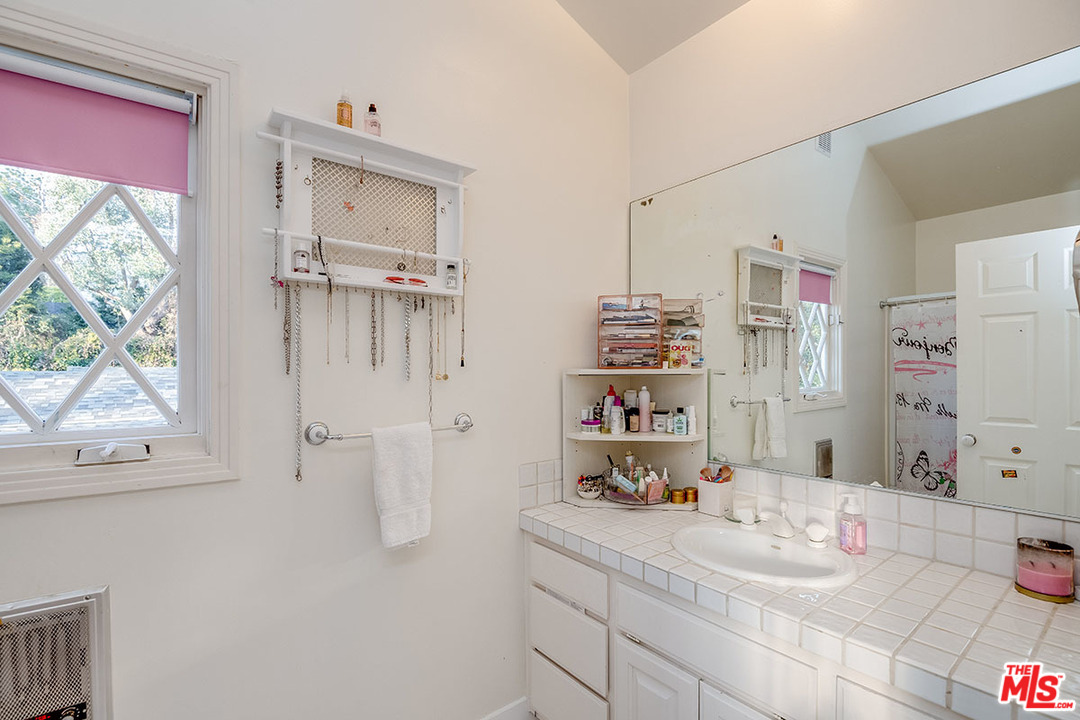 20 Toluca Estates Drive Toluca Lake, CA 91602 - Photo 41 of 46 a bathroom with a sink vanity granite and a shower