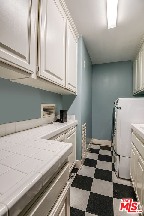 20 Toluca Estates Drive Toluca Lake, CA 91602 - Photo 46 of 46 a kitchen with a refrigerator and cabinets