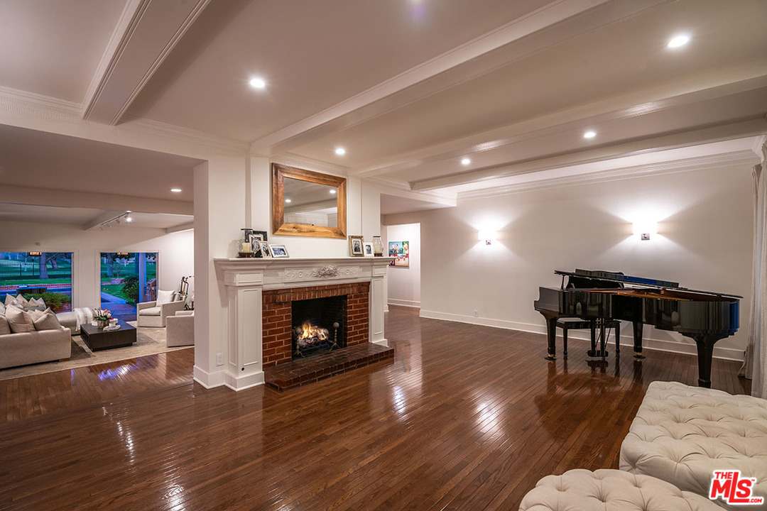 20 Toluca Estates Drive Toluca Lake, CA 91602 - Photo 10 of 46 a living room with furniture a fireplace and wooden floor