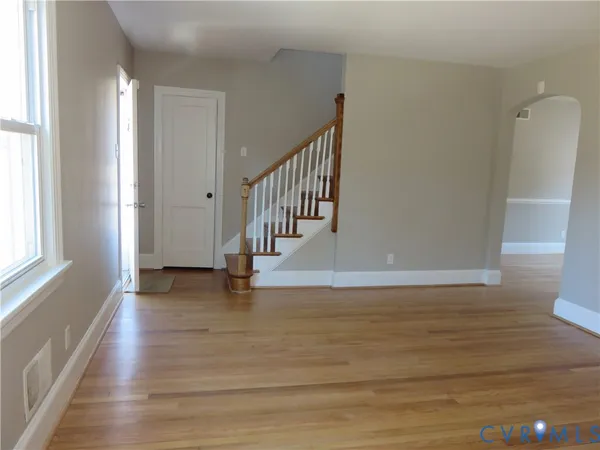 a view of an entryway with wooden floor