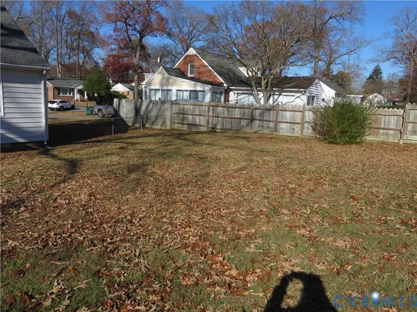 a view of a yard with a large tree