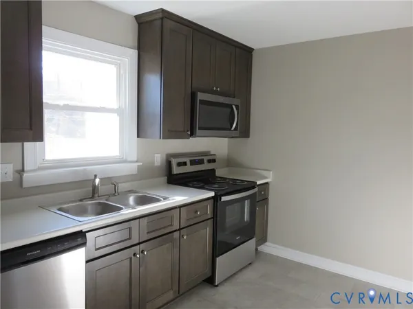a kitchen with a sink stove and microwave