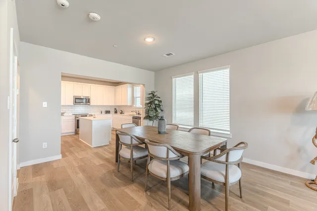 a view of a dining room with furniture and window