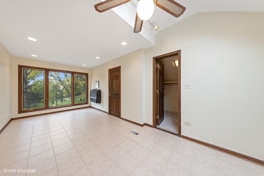 6318 Martin Drive Willowbrook, IL 60527 - Photo 18 of 33 a view of a livingroom with a ceiling fan and window