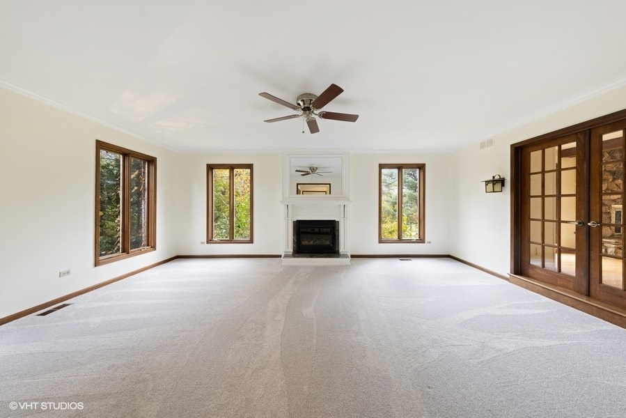 6318 Martin Drive Willowbrook, IL 60527 - Photo 5 of 33 an empty room with windows and fireplace