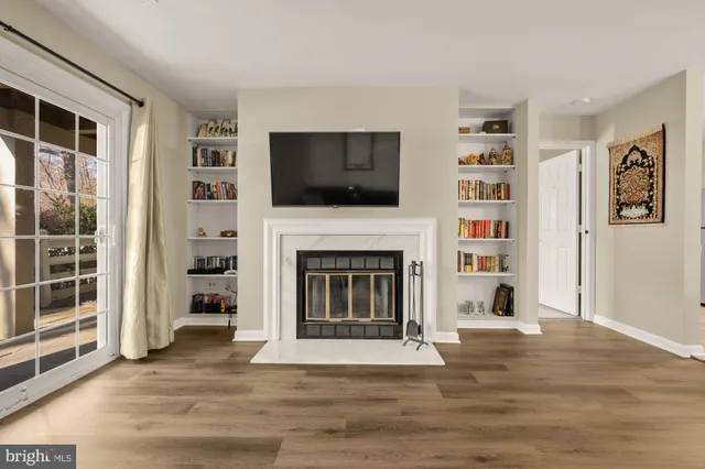 a living room with a fireplace and a flat screen tv