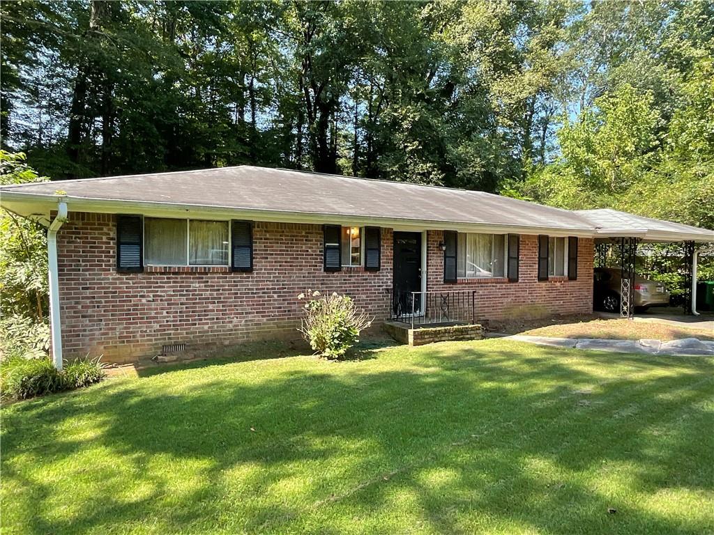 1595 Moncrief Circle Decatur, GA 30033 - Photo 1 of 1 a front view of a house with a garden