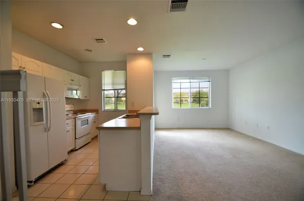 a kitchen with refrigerator and window