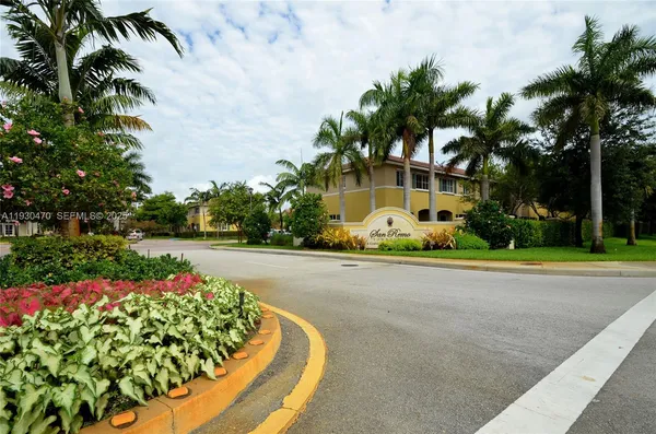a front view of a house with a yard and a garden